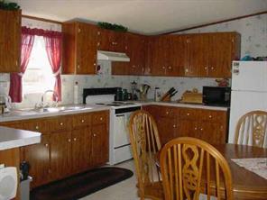 967 Tot Dellinger Road Cherryville, NC 28021 - Photo 4 of 7 a kitchen with a sink a stove a microwave a sink a refrigerator and cabinets