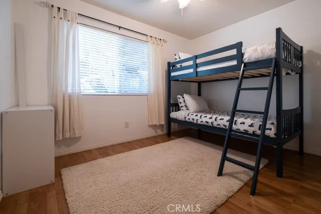 a bedroom with a bed a window and a desk