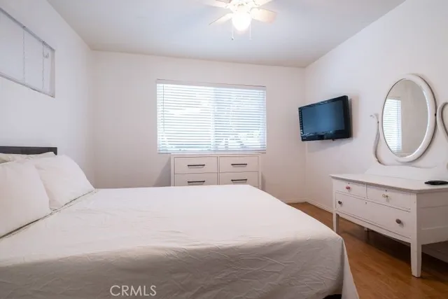 a bedroom with a bed and a flat screen tv