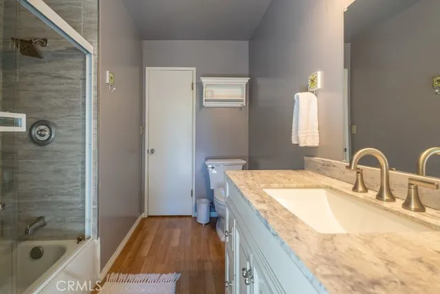 a bathroom with a granite countertop sink a bathtub and a shower