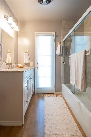 a bathroom with a tub sink and a mirror