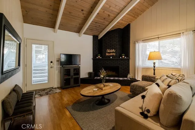 a living room with fireplace furniture and a flat screen tv