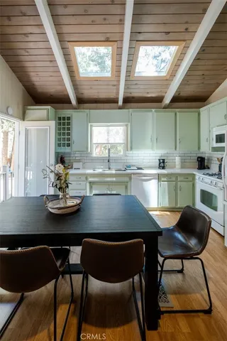 a kitchen with a table chairs stove and cabinets