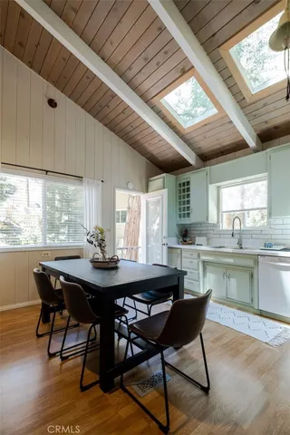 a dining room with a wooden table and chairs