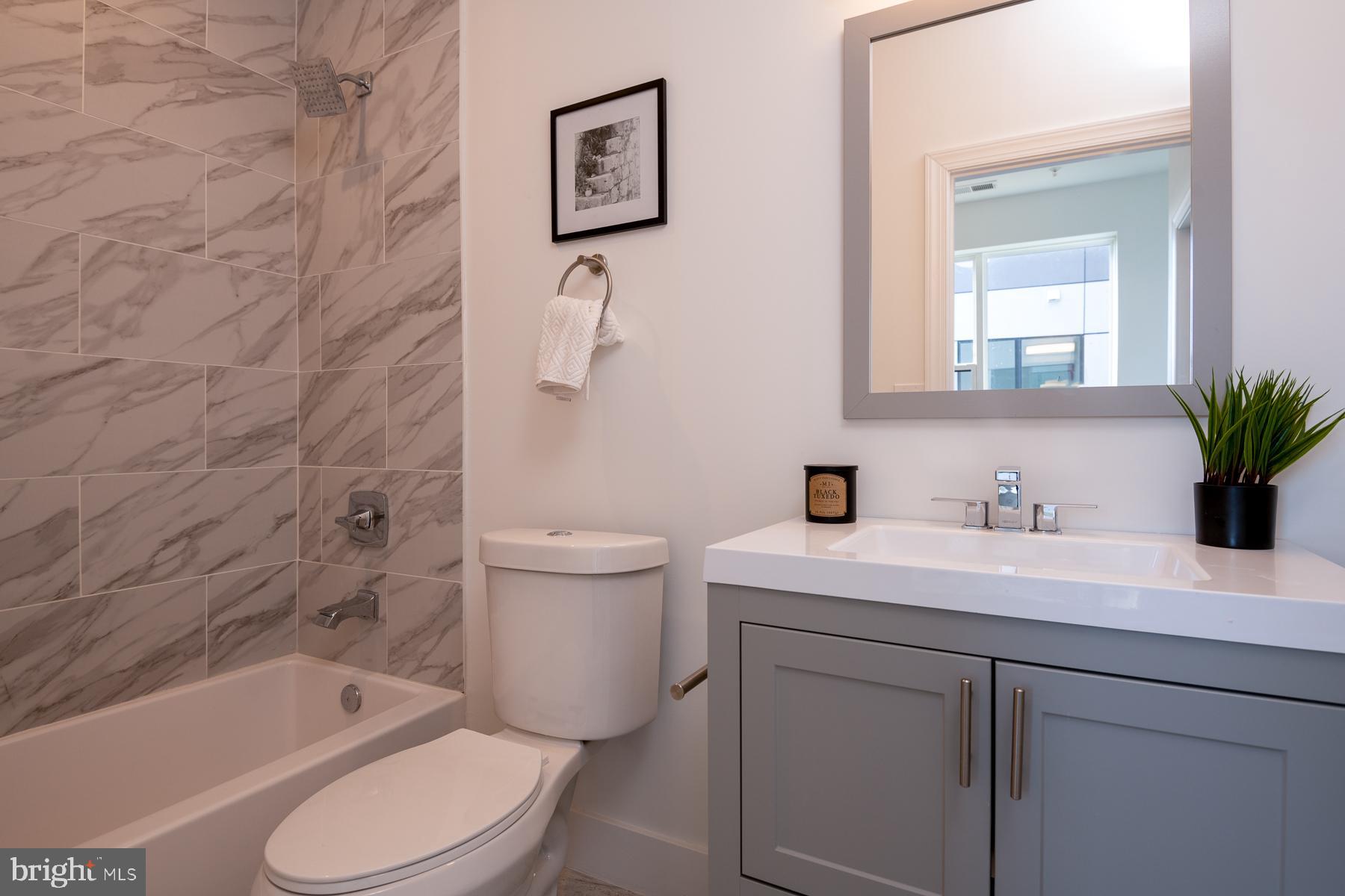 818 Bladensburg Road Northeast, Unit 203 Washington, DC 20002 - Photo 5 of 13 a bathroom with a sink toilet and shower