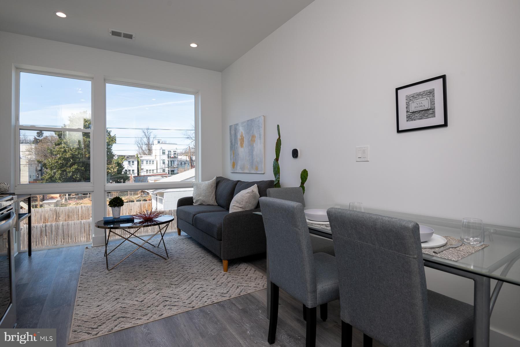 818 Bladensburg Road Northeast, Unit 203 Washington, DC 20002 - Photo 7 of 13 a living room with furniture and a large window