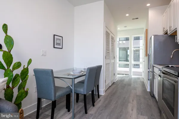 a view of a dining room with furniture window and wooden floor