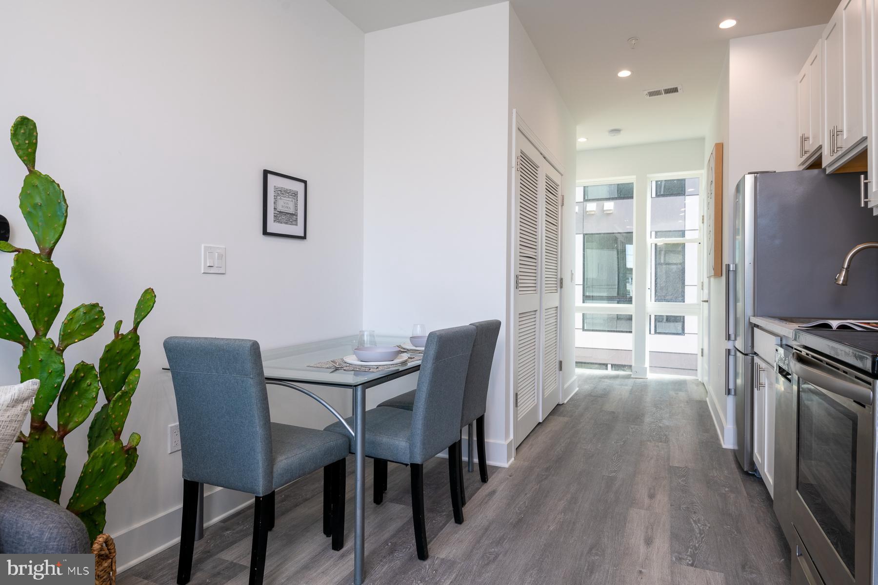 818 Bladensburg Road Northeast, Unit 203 Washington, DC 20002 - Photo 10 of 13 a view of a dining room with furniture window and wooden floor