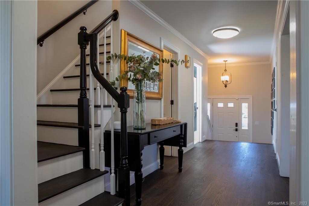 331 Riverside Drive Fairfield, CT 06824 - Photo 13 of 34 a view of a hallway with wooden floor and staircase