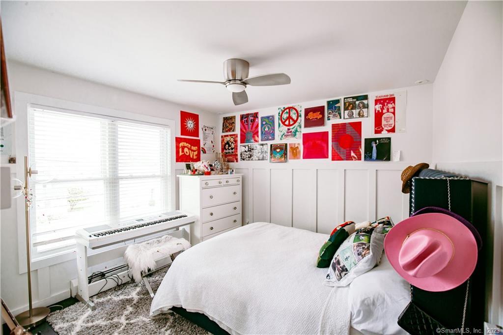 331 Riverside Drive Fairfield, CT 06824 - Photo 14 of 34 a bedroom with a bed a dresser and a large window