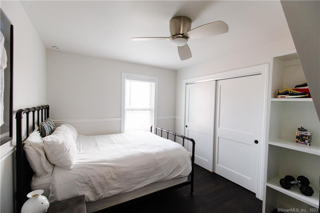 331 Riverside Drive Fairfield, CT 06824 - Photo 16 of 34 a bedroom with a bed and a ceiling fan