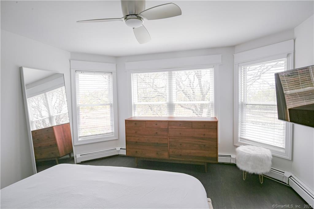 331 Riverside Drive Fairfield, CT 06824 - Photo 19 of 34 a bedroom with a bed and a chair