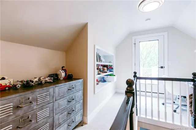 a bedroom with furniture and baby crib