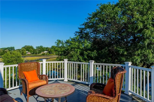 a view of a chair and table on the deck