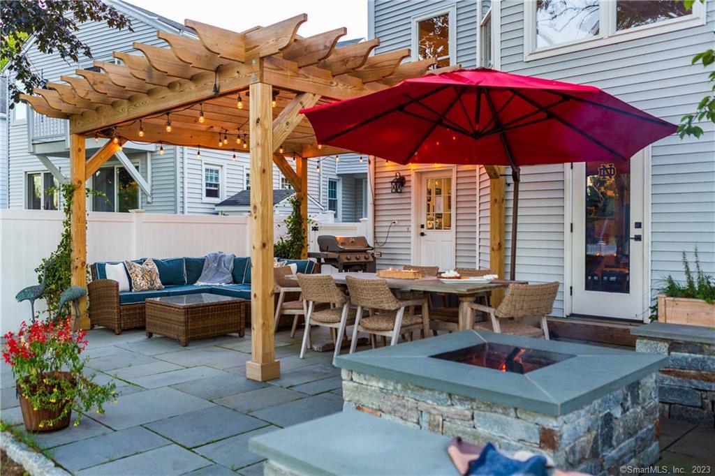 331 Riverside Drive Fairfield, CT 06824 - Photo 27 of 34 a view of the patio with couches table and chairs under an umbrella