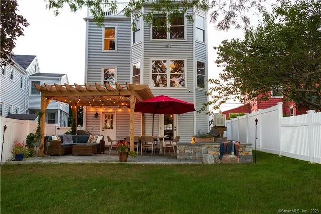 a view of a house with a yard and sitting area