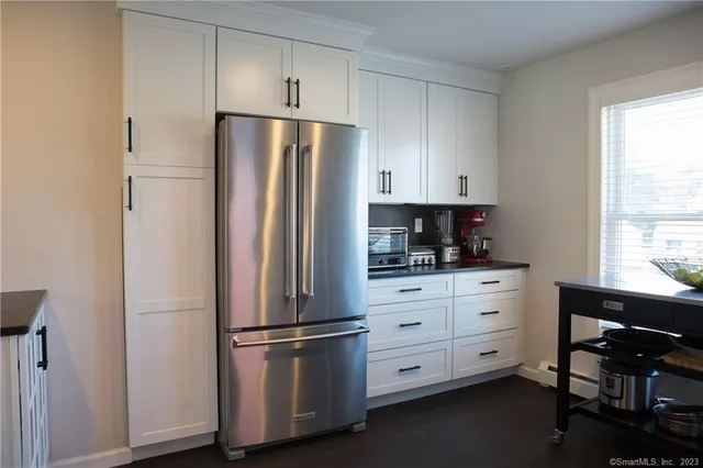 a kitchen with cabinets stainless steel appliances and window