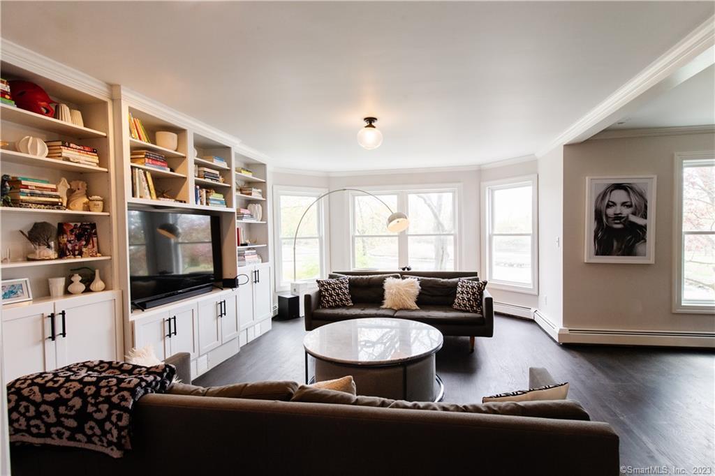 331 Riverside Drive Fairfield, CT 06824 - Photo 8 of 34 a living room with furniture and a flat screen tv