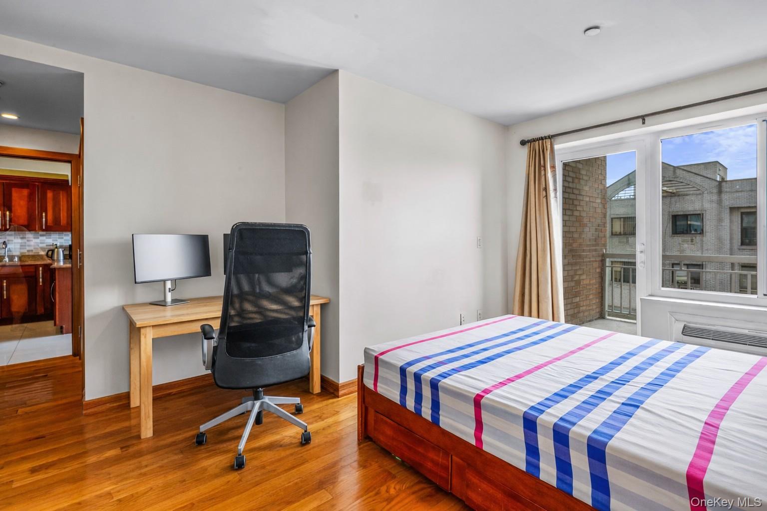 37-17 111th Street, Unit 4F Queens, NY 11368 - Photo 11 of 19 a bedroom with a bed and a chair in it
