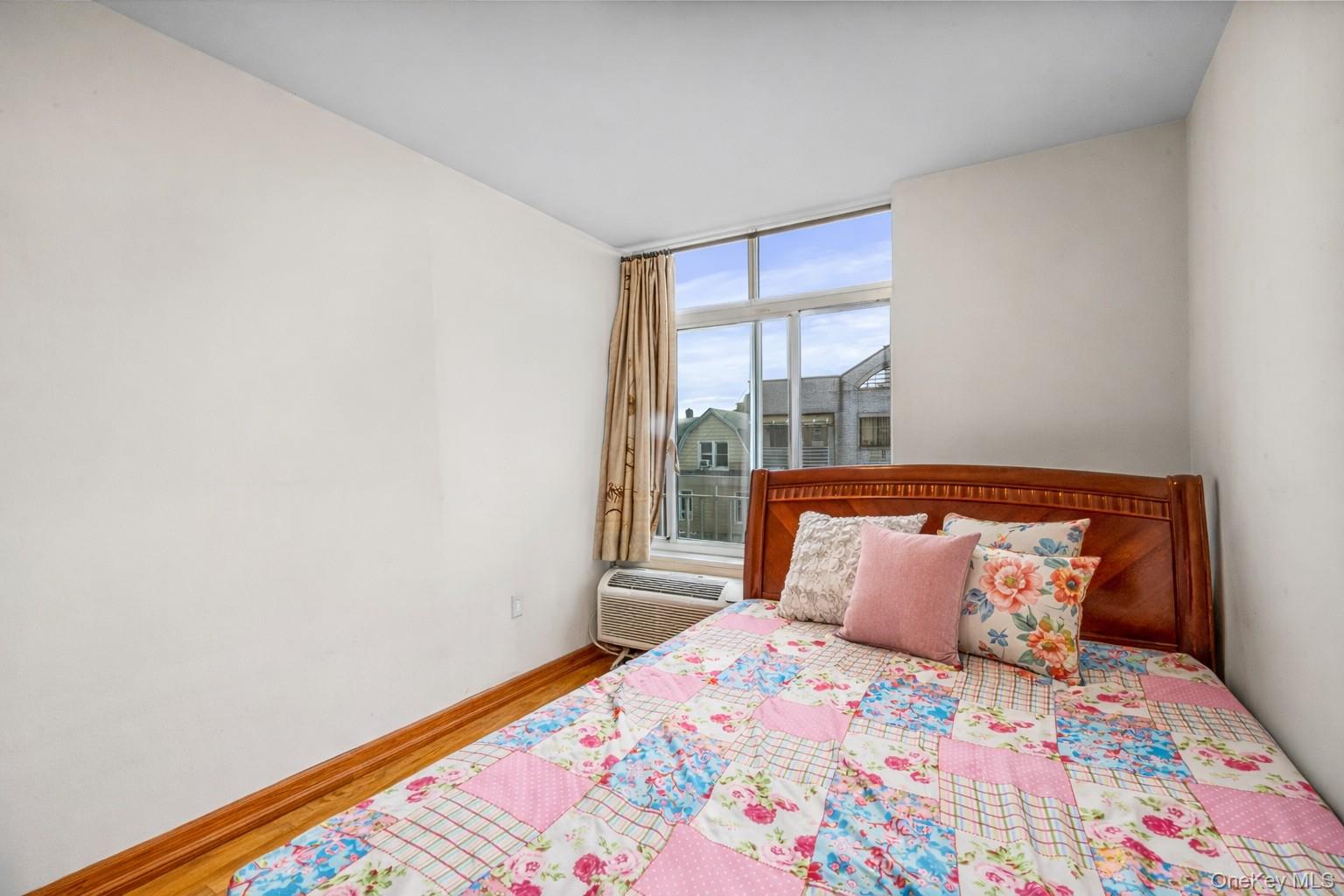 37-17 111th Street, Unit 4F Queens, NY 11368 - Photo 15 of 19 a bedroom with a bed and a window
