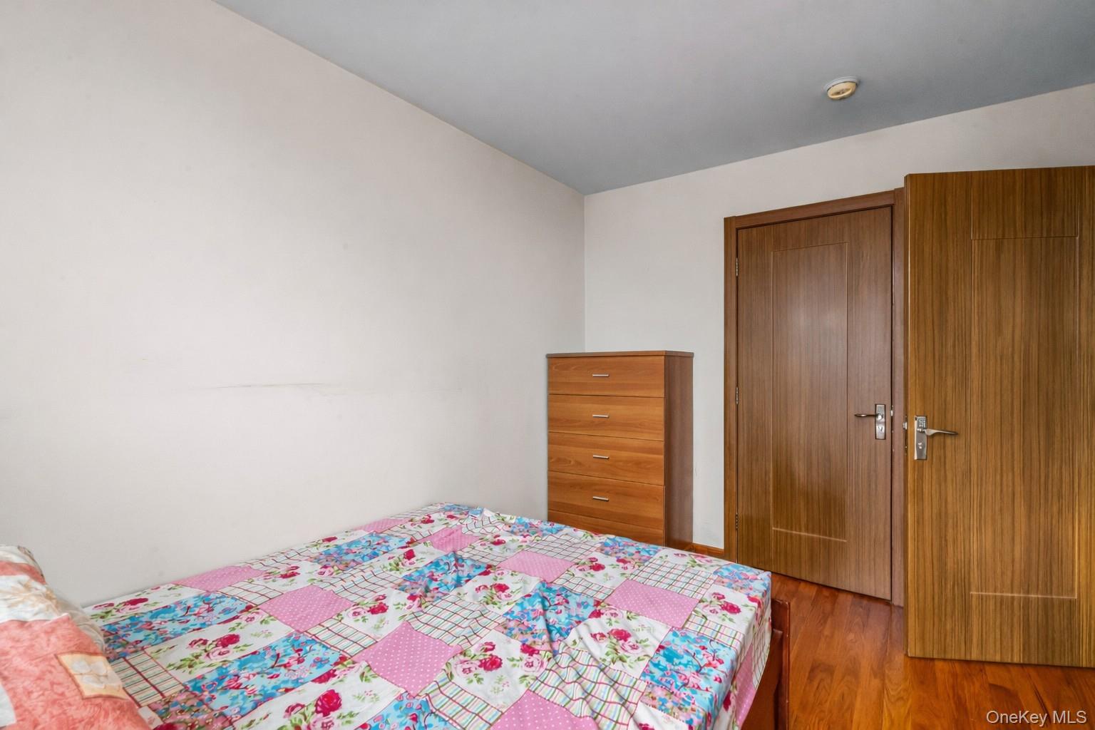 37-17 111th Street, Unit 4F Queens, NY 11368 - Photo 16 of 19 a bedroom with a bed and a dresser