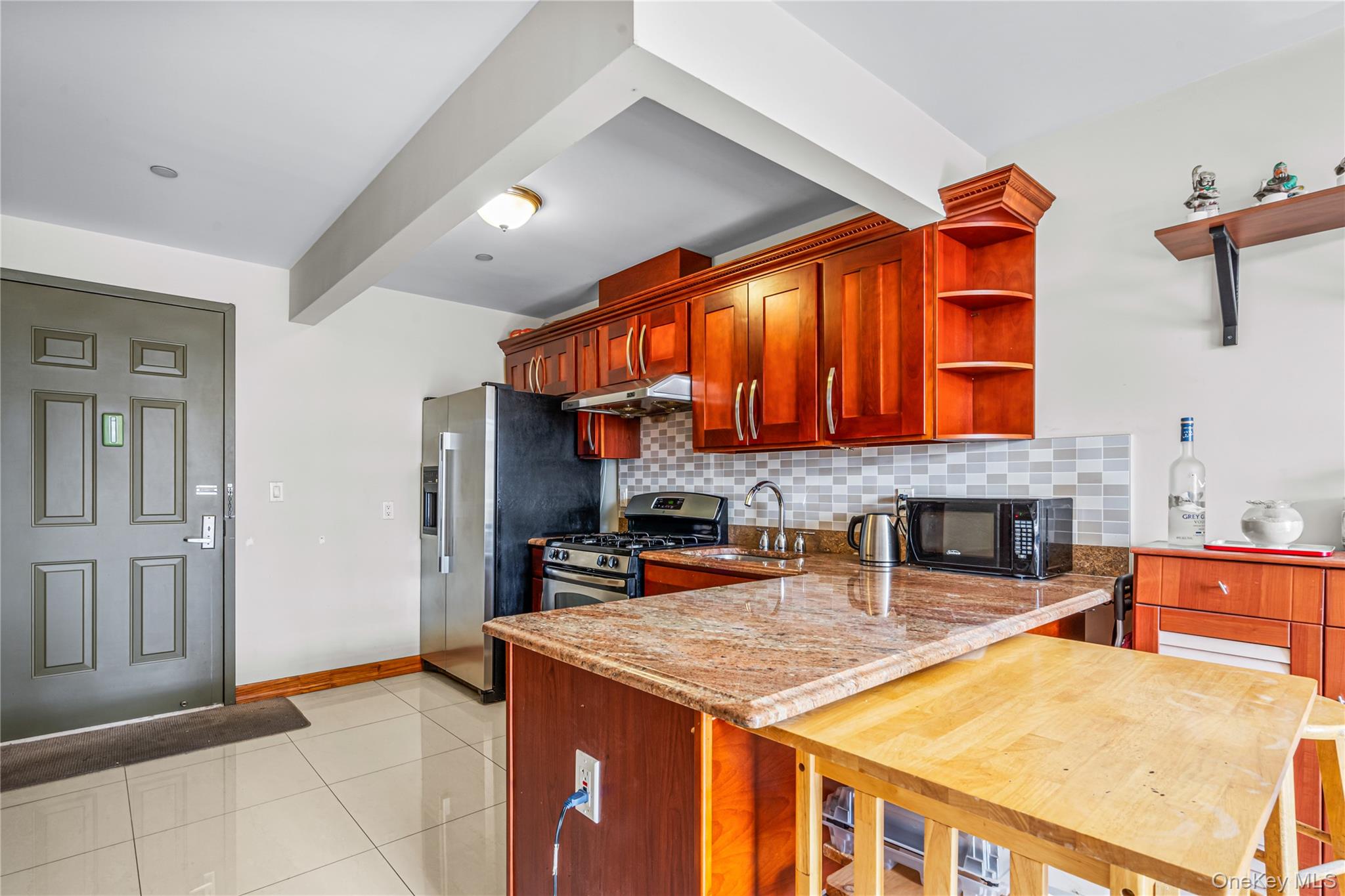 37-17 111th Street, Unit 4F Queens, NY 11368 - Photo 7 of 19 a kitchen with stainless steel appliances granite countertop a sink and cabinets