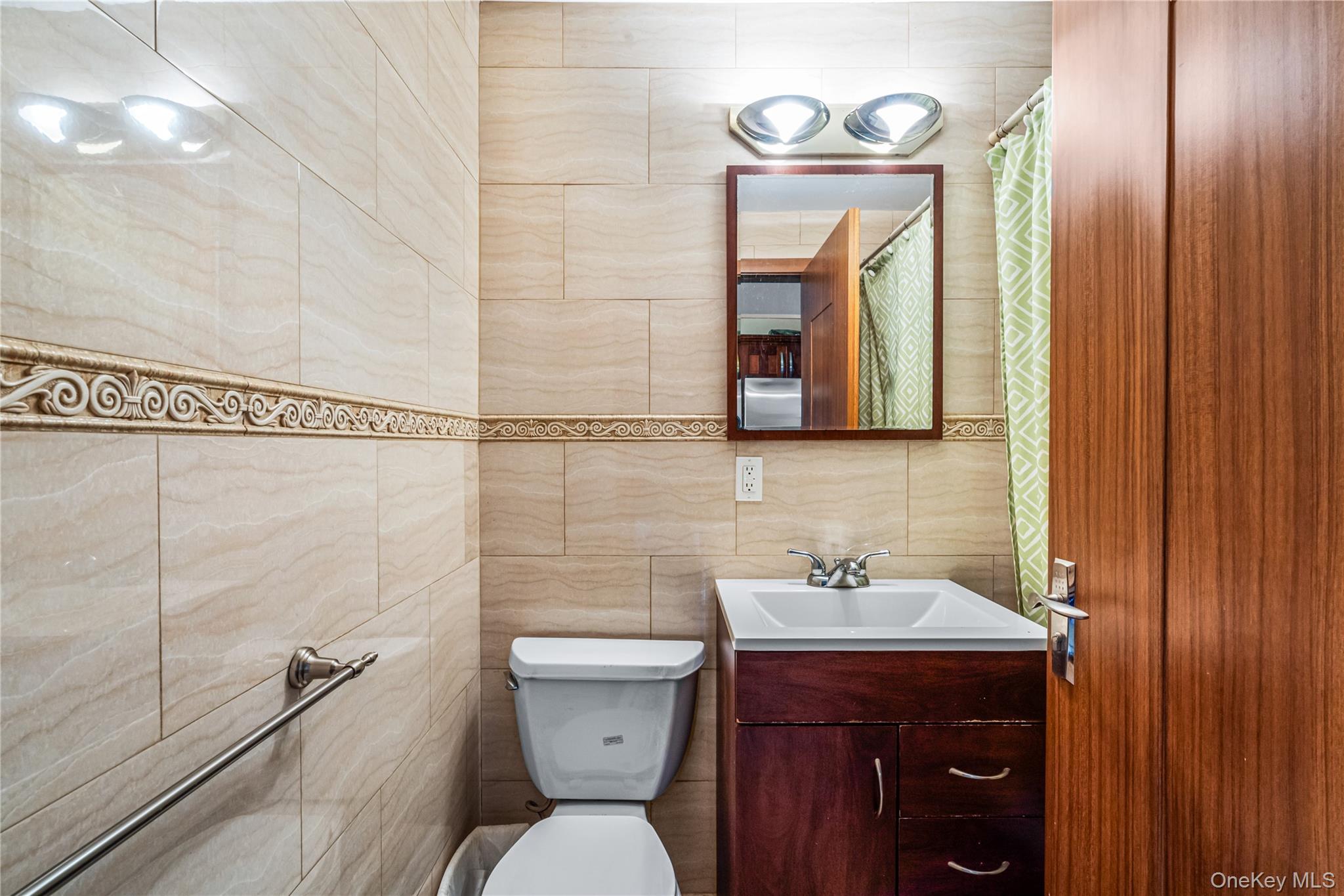 37-17 111th Street, Unit 4F Queens, NY 11368 - Photo 9 of 19 a bathroom with a toilet sink and mirror