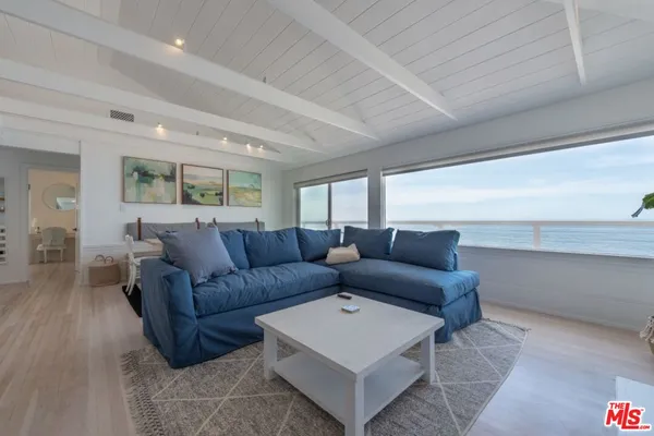 a living room with furniture and kitchen view