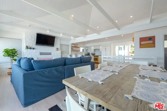 a view of a dining room with furniture a chandelier and wooden floor