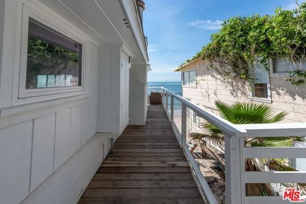 a view of staircase with white walls and white door