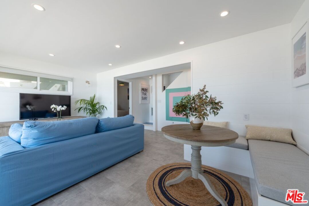 24942 Malibu Road Malibu, CA 90265 - Photo 28 of 44 a living room with furniture a flat screen tv and a fireplace