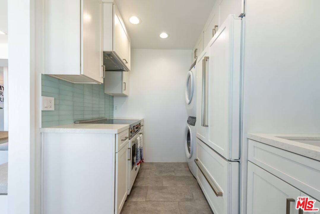 24942 Malibu Road Malibu, CA 90265 - Photo 29 of 44 a kitchen with a sink and refrigerator