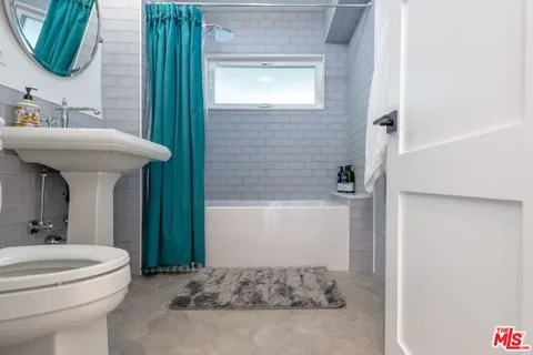 a bedroom with a bed and couch