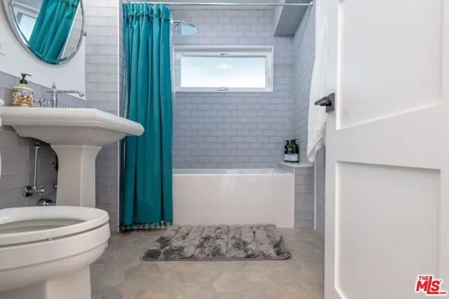 a bedroom with a bed and couch