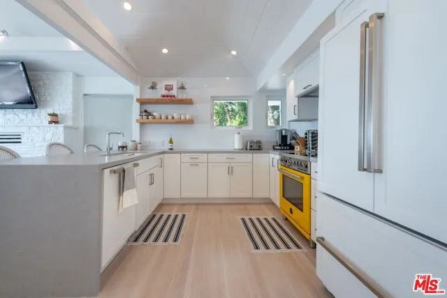 a living room with stainless steel appliances kitchen island granite countertop furniture and a kitchen view