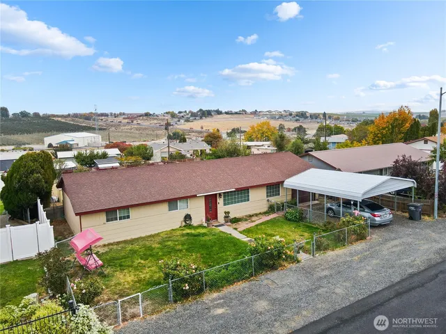 a view of a house with a garden and lake view