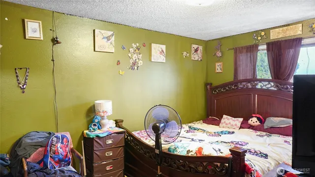 a bedroom with a bed and ceiling fan