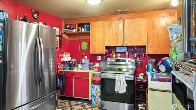a kitchen with stainless steel appliances granite countertop a refrigerator and a stove