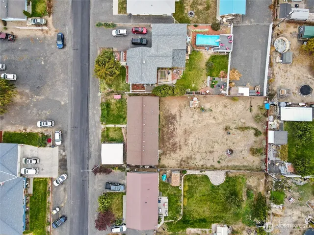an aerial view of residential houses with outdoor space