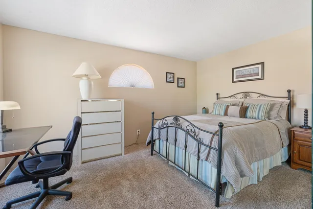 a living room with furniture a flat screen tv and a large window