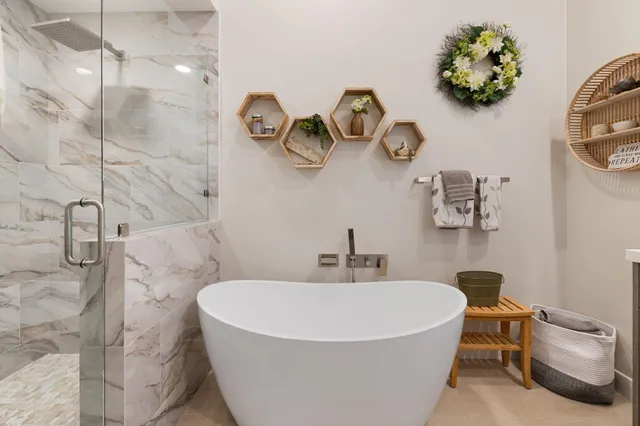a spacious bathroom with a tub sink and mirror