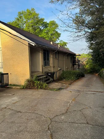 a backyard of a house with plants and trees