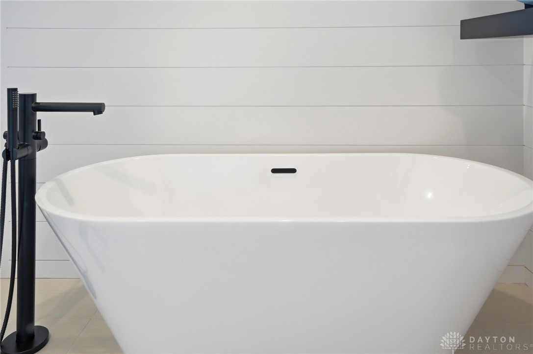 1247 Normandy Rue Dayton, OH 45458 - Photo 25 of 76 This serene bathroom offers a luxurious soaking tub with contemporary fixtures for ultimate relaxation.