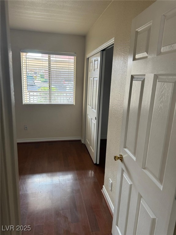 5021 River Glen Drive, Unit 41 Las Vegas, NV 89103 - Photo 11 of 12 Hall with dark wood finished floors, baseboards, a