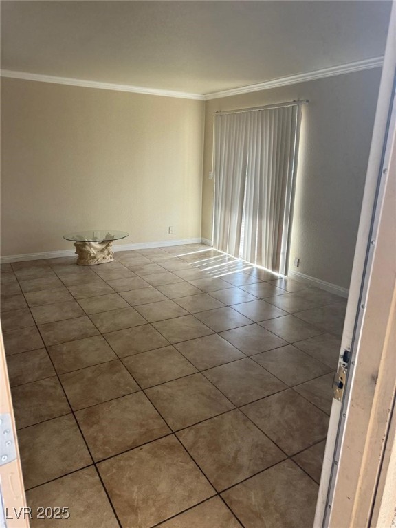 5021 River Glen Drive, Unit 41 Las Vegas, NV 89103 - Photo 7 of 12 Spare room featuring crown molding, tile patterned