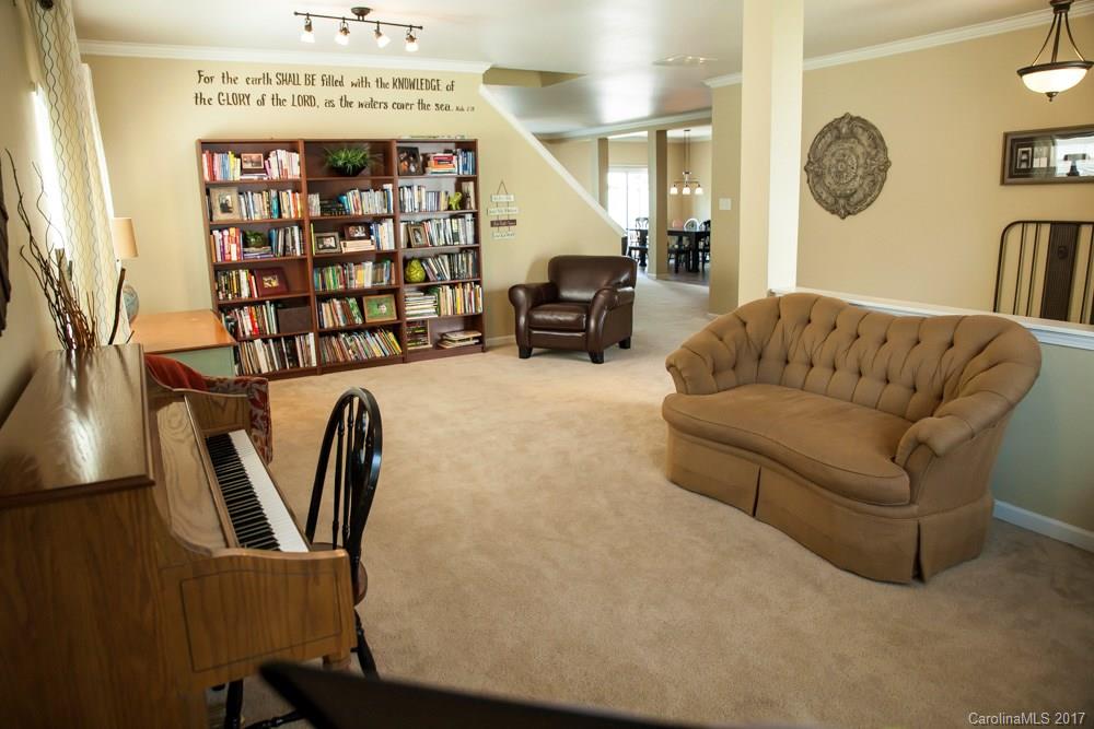2069 Durand Road Fort Mill, SC 29715 - Photo 3 of 23 a living room with furniture a window and bookshelf