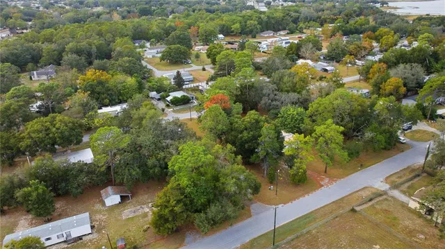 an aerial view of a houses with yard