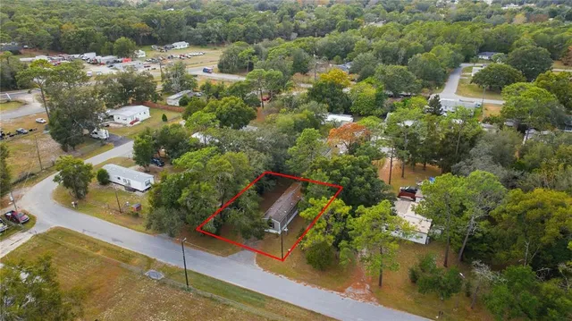an aerial view of residential houses with outdoor space and street view
