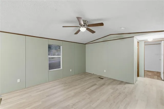a view of room with a ceiling fan and a hardwood floor