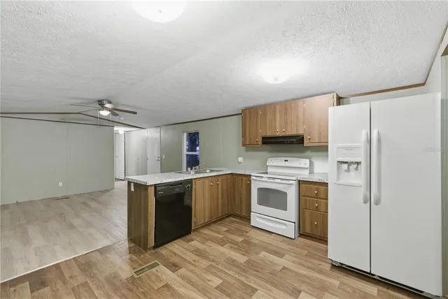a kitchen with stainless steel appliances a stove sink and refrigerator